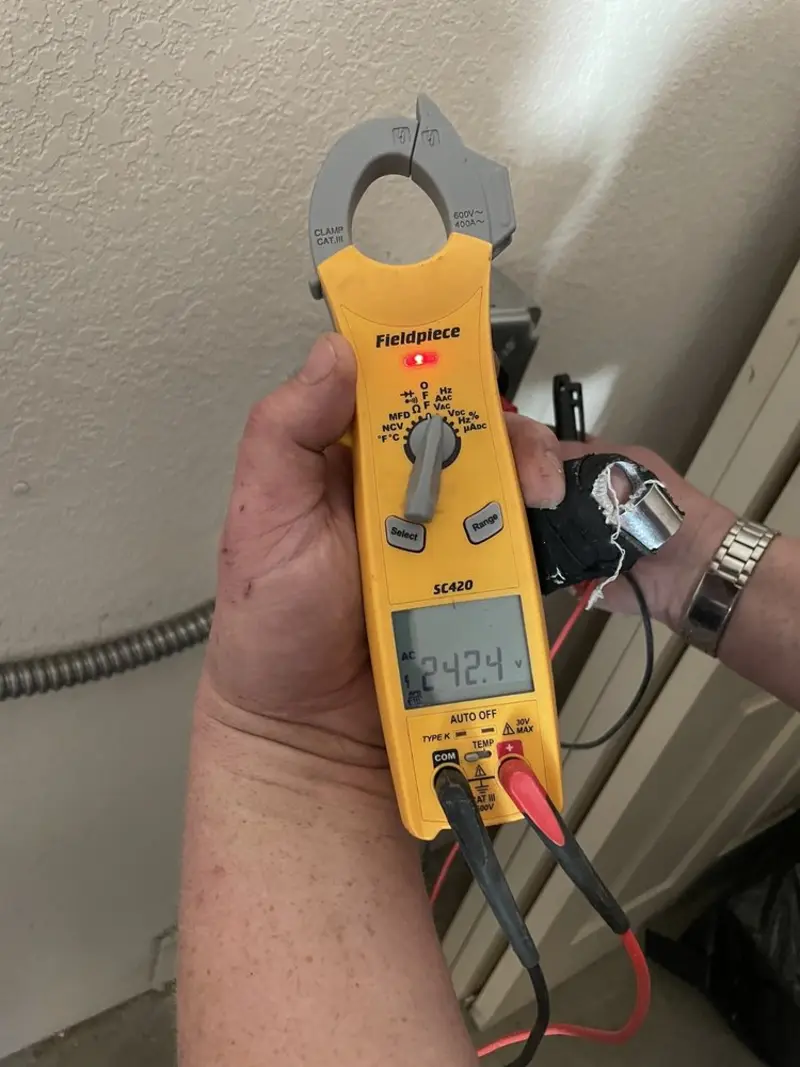 Voltage testing with clamp meter during Outlet Installation in Woburn